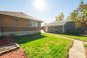 View of green lawn with a vegetable garden