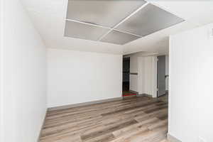 Spare room with light wood-style floors and a drop ceiling