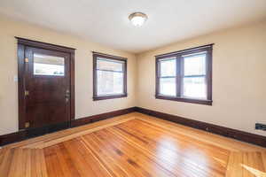 Foyer entrance featuring hardwood / wood-style floors and a textured ceiling