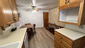 Dining room with light wood-style flooring and a ceiling fan