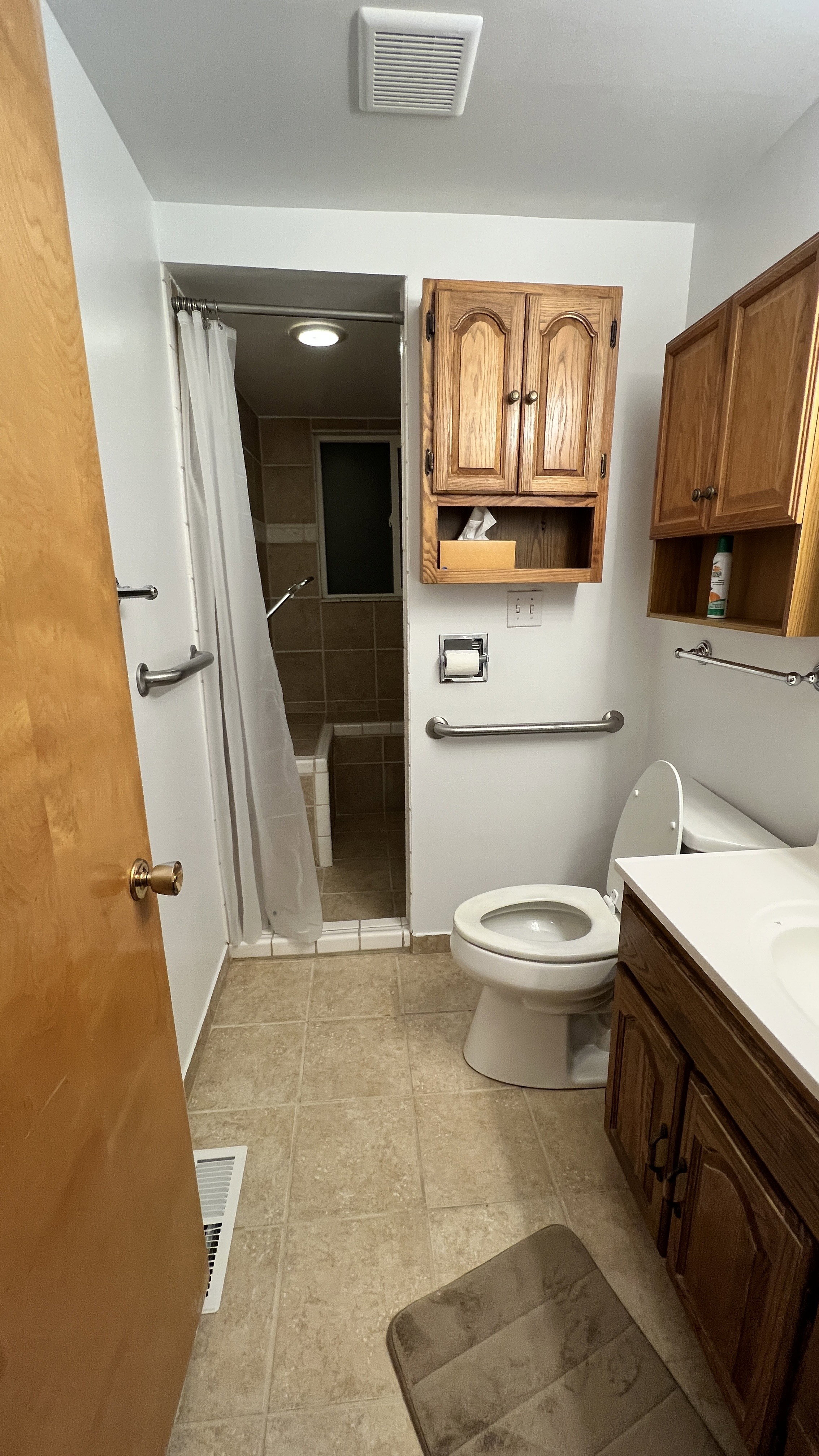 Full bathroom with vanity, a stall shower, and light tile patterned floors