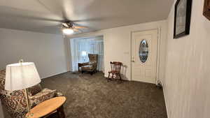 Sitting room featuring carpet floors and a ceiling fan
