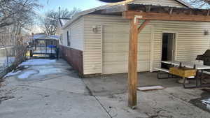 Exterior space with a  patio cover and rear garage door.