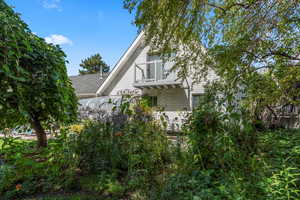 View of side of home featuring a balcony