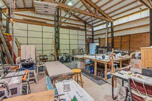 Garage featuring a workshop area and metal wall