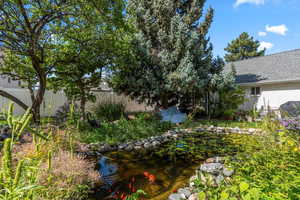 View of yard with a garden pond