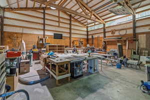 Garage featuring a workshop area and wood walls