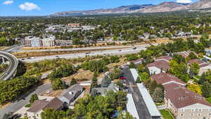 Aerial perspective of suburban area featuring mountains and a main thoroughfare