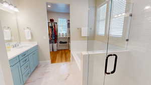 Primary bathroom with separate tub and shower with Euro glass surround.