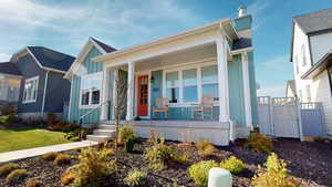 View of front of house with board and batten siding, and a porch
