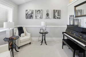 Living area with vaulted ceiling and carpet