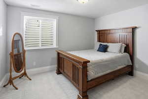 Bedroom featuring baseboards and a textured ceiling