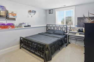 Bedroom with a textured ceiling and tile patterned floors