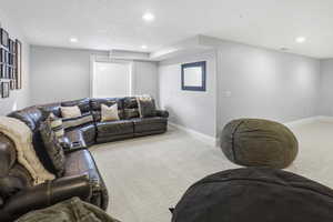 Living room with recessed lighting and light carpet