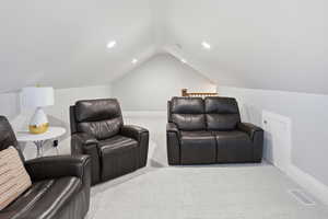 Cinema with light colored carpet, lofted ceiling, and recessed lighting