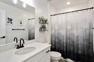 Bathroom featuring vanity and toilet