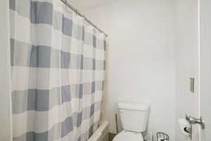 Bathroom with toilet and shower / bath combo