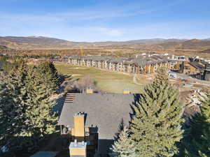Aerial view of property's location with a mountain backdrop and nearby suburban area
