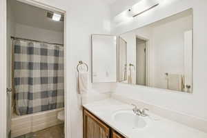 Bathroom featuring vanity and shower / bath combo with shower curtain