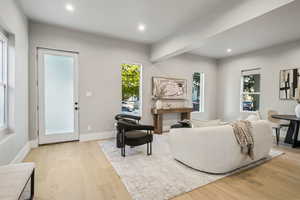 Living room featuring light wood-style floors and recessed lighting