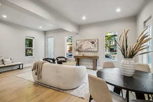 Living area with recessed lighting and light wood-style flooring