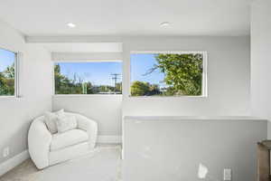 Living area with recessed lighting and carpet