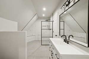 Bathroom featuring vanity, a walk in shower, and recessed lighting