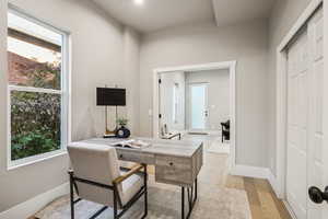 Office space featuring baseboards and light wood finished floors