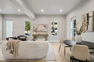Living room featuring light wood finished floors, recessed lighting, and healthy amount of natural light
