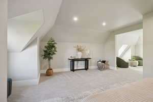 Additional living space with carpet floors, vaulted ceiling, and recessed lighting
