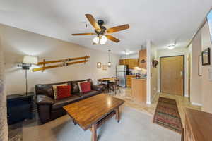 Living room featuring a ceiling fan and light tile patterned flooring