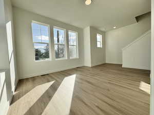 Unfurnished living room with light wood finished floors and recessed lighting