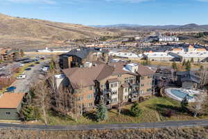 Aerial overview of property's location featuring nearby suburban area and a mountain backdrop