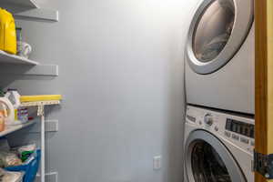 Laundry area featuring stacked washing machine and dryer