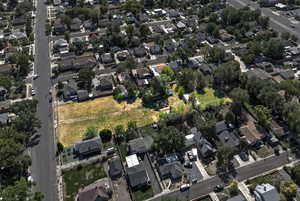 Aerial view of property and surrounding area featuring nearby suburban area