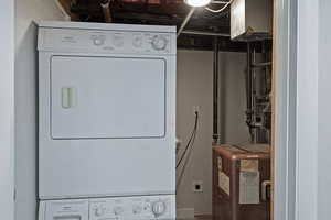Washroom featuring stacked washer / dryer
