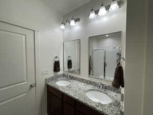Master Bathroom with a shower with curtain and double vanity