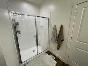 Master Bathroom with a shower stall and dark wood-style floors