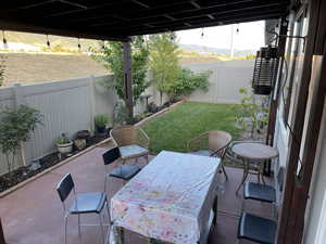 Fenced backyard with a patio area and a mountain view