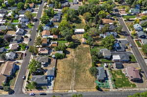 Aerial view of property and surrounding area featuring nearby suburban area