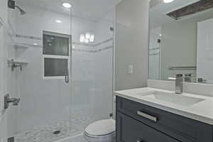 Bathroom featuring vanity and a shower stall