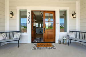 View of exterior entry with a large, inviting  front porch
