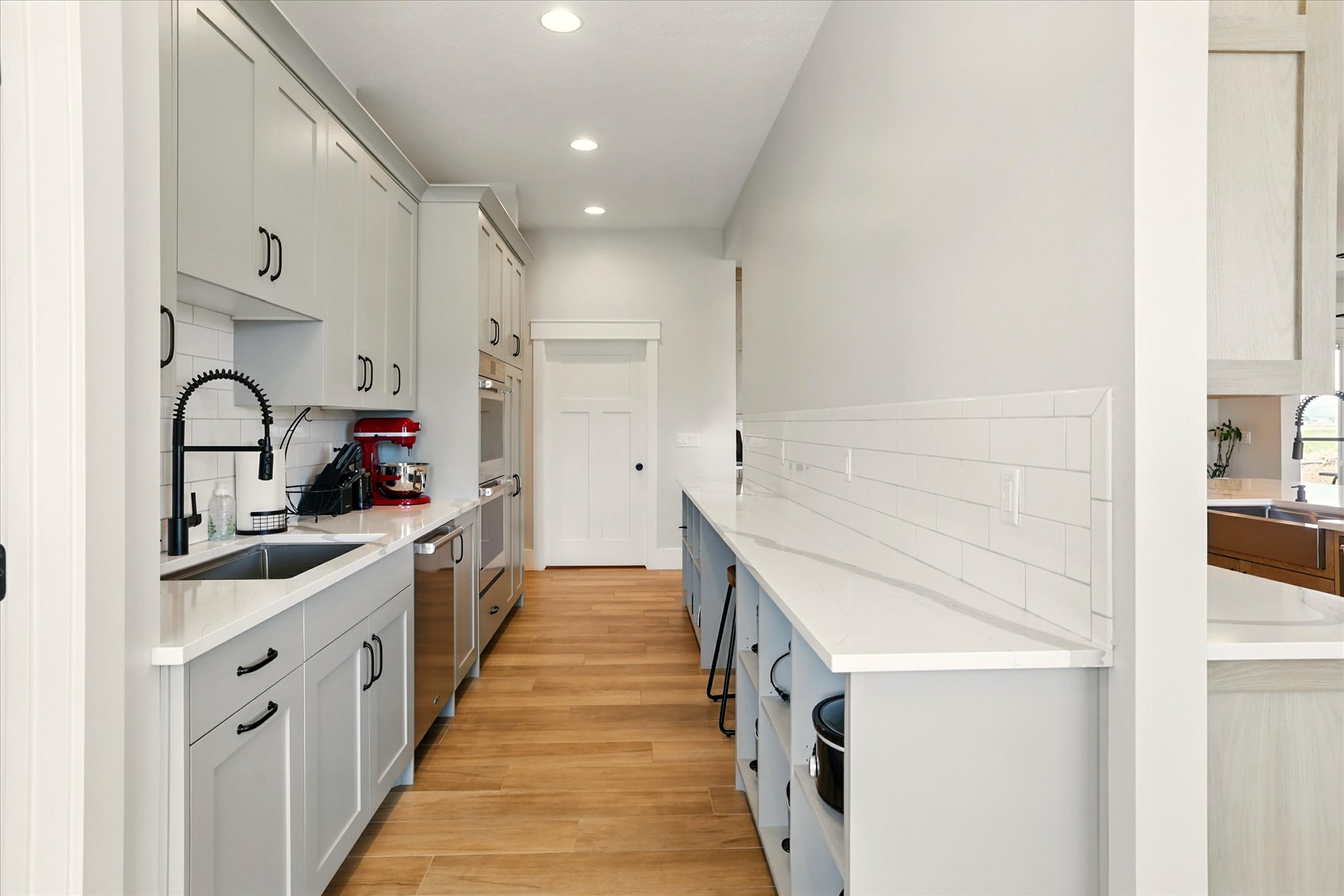 Prep-Kitchen with tasteful backsplash, light stone countertops, recessed lighting, light wood-type flooring, and stainless steel dishwasher