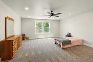 Carpeted bedroom with ceiling fan, recessed lighting, and a textured ceiling