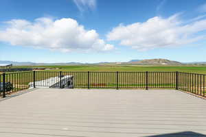 Wooden deck with a mountain view and a view of rural / pastoral area