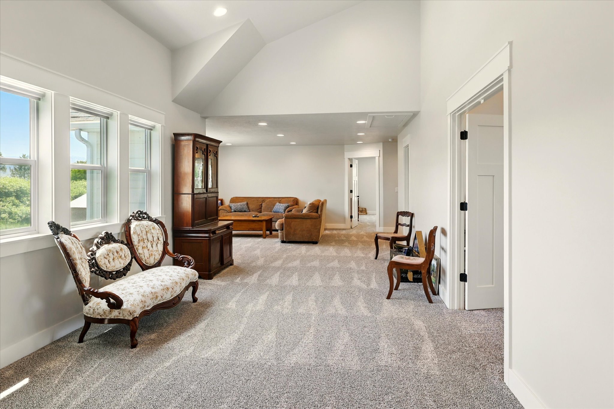 Sitting room featuring recessed lighting, light carpet, and high vaulted ceiling