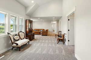 Sitting room featuring recessed lighting, light carpet, and high vaulted ceiling