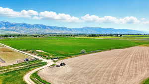 Overview of farmland featuring a mountain backdrop