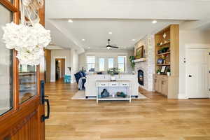Living area featuring a fireplace, light wood-type flooring, recessed lighting, and ceiling fan