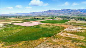 View of rural area featuring extensive farmland and a mountain backdrop